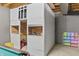 Finished basement with a built-in playroom area, complete with storage and play space, adding unique charm at 2326 Gradison Cir, Indianapolis, IN 46214