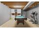 Finished basement showcasing a billiards table and exercise bike, offering entertainment and fitness options at 2326 Gradison Cir, Indianapolis, IN 46214