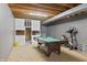 Finished basement featuring a billiards table and exercise bike, perfect for recreation and fitness at 2326 Gradison Cir, Indianapolis, IN 46214