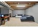 Finished basement featuring a spacious lounge area with plush seating, a TV, and carpeted floors for a comfortable retreat at 2326 Gradison Cir, Indianapolis, IN 46214