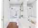 Bright bathroom featuring a white vanity, wooden floors, and Paris-themed shower curtain at 2326 Gradison Cir, Indianapolis, IN 46214