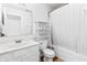 Bright white bathroom featuring a white vanity and tub/shower combination with storage at 2326 Gradison Cir, Indianapolis, IN 46214