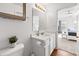 White bathroom featuring a mirror, toilet with vanity, and view into bedroom at 2326 Gradison Cir, Indianapolis, IN 46214