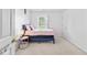 Bedroom featuring a bed with pink covers, a nightstand, and a window with curtains at 2326 Gradison Cir, Indianapolis, IN 46214