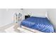 Bright bedroom featuring a bed with a blue comforter, a nightstand, and shelving unit at 2326 Gradison Cir, Indianapolis, IN 46214