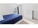 Bedroom featuring a window, white walls, a white dresser and a bed with blue covers at 2326 Gradison Cir, Indianapolis, IN 46214