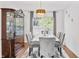 Bright dining room with a marble table, six grey velvet chairs, and decorative cabinet at 2326 Gradison Cir, Indianapolis, IN 46214
