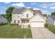 Charming two-story home featuring a combination of brick and vinyl siding with an attached two car garage at 2326 Gradison Cir, Indianapolis, IN 46214