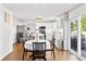 Bright kitchen with island seating connected to a dining area and access to outdoor patio at 2326 Gradison Cir, Indianapolis, IN 46214