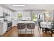 Modern kitchen with stainless steel appliances, a central island, and a dining area with backyard access at 2326 Gradison Cir, Indianapolis, IN 46214