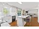 Open concept kitchen with island seating, stainless appliances, and access to outdoor patio area at 2326 Gradison Cir, Indianapolis, IN 46214