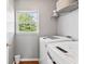 Functional laundry area featuring modern washer and dryer set with a view of the yard at 2326 Gradison Cir, Indianapolis, IN 46214