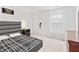 Bright main bedroom features a sleek platform bed, soft carpet, and a window with a view at 2326 Gradison Cir, Indianapolis, IN 46214