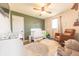 Bright bedroom with a crib, chair, and natural light, designed for comfort and style at 272 Jefferson St, Columbus, IN 47201
