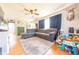 Open-concept living room with hardwood floors, a large sectional sofa, and natural light at 272 Jefferson St, Columbus, IN 47201