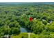 Expansive aerial view highlighting the property's location near a serene lake amidst lush greenery at 2805 Fox E Ct, Martinsville, IN 46151