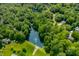 Breathtaking aerial view of a lake with surrounding houses and dense trees, offering a sense of community at 2805 Fox E Ct, Martinsville, IN 46151