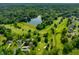 Breathtaking aerial view of the golf course community with mature trees and a beautiful lake at 2805 Fox E Ct, Martinsville, IN 46151