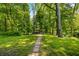 Picturesque stone pathway leading to a charming gazebo surrounded by lush greenery at 2805 Fox E Ct, Martinsville, IN 46151