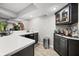 Basement bar area with white countertops, under-counter refrigerator, and cabinet display at 2805 Fox E Ct, Martinsville, IN 46151