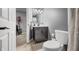 Cozy bathroom featuring gray walls, vanity with mirror, and white toilet, blending modern aesthetics at 2805 Fox E Ct, Martinsville, IN 46151