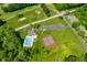 Aerial shot including a pool, tennis court, parking and greenery, perfect for an active lifestyle at 2805 Fox E Ct, Martinsville, IN 46151