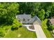 Aerial view of charming home boasting mature trees, a well manicured lawn and a long driveway at 2805 Fox E Ct, Martinsville, IN 46151