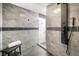 Tiled shower area with gray accent tiles, a comfortable bench, and modern fixtures at 2805 Fox E Ct, Martinsville, IN 46151
