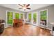 Sun room features hardwood floors, a piano, and lots of windows with a view to the exterior at 2805 Fox E Ct, Martinsville, IN 46151
