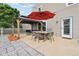 Backyard patio with gazebo, seating, dining table, and red umbrella, perfect for entertaining at 2887 Ludwig Dr, Indianapolis, IN 46239