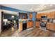 Open kitchen with wood cabinets, stainless steel appliances, and wood-look flooring at 2887 Ludwig Dr, Indianapolis, IN 46239