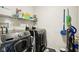 Efficient laundry room featuring a modern washer and dryer set with ample shelving for storage at 2887 Ludwig Dr, Indianapolis, IN 46239