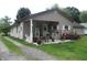 Charming single story home with covered porch and comfortable outdoor seating area at 29 Home Ave, Markleville, IN 46056