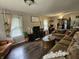 Spacious living room with hardwood floors, comfortable seating, and bright windows, perfect for relaxing and entertaining guests at 29 Home Ave, Markleville, IN 46056