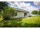 Well-maintained backyard with lush green lawn, mature trees and patio with sliding door access at 2905 Inverrary Ct, Indianapolis, IN 46234