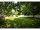 Expansive backyard features lush lawn, mature trees and a privacy fence at 2905 Inverrary Ct, Indianapolis, IN 46234