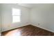This empty bedroom features hardwood floors and a window offering plenty of natural light at 2905 Inverrary Ct, Indianapolis, IN 46234
