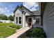 Charming home exterior with a red front door, grey siding, and landscaped front yard at 2905 Inverrary Ct, Indianapolis, IN 46234