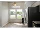 Kitchen with view of front yard offers stainless steel refrigerator and eat in breakfast nook at 2905 Inverrary Ct, Indianapolis, IN 46234