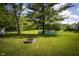 Picturesque pond with a fire pit in the foreground and homes in the background at 2905 Inverrary Ct, Indianapolis, IN 46234
