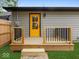 Backyard with a new deck and a bright yellow door at 31 Mckenzie St, Shelbyville, IN 46176