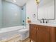 Bright bathroom featuring a bathtub with tile surround and a vanity with marble countertop at 31 Mckenzie St, Shelbyville, IN 46176