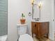 Bathroom featuring a toilet, a vanity with marble countertop, and an arched mirror at 31 Mckenzie St, Shelbyville, IN 46176