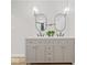 Bright bathroom features a double vanity, two mirrors, wood-look floors and modern lighting at 31 Mckenzie St, Shelbyville, IN 46176