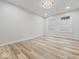 This bright bedroom has light paint, recessed lighting, wood-look floors, and two windows at 31 Mckenzie St, Shelbyville, IN 46176