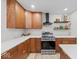 Modern kitchen featuring stainless steel appliances, wood cabinets, and white countertops at 31 Mckenzie St, Shelbyville, IN 46176