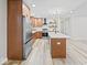 Modern kitchen with stainless steel appliances, white countertops, wood cabinets, and kitchen island at 31 Mckenzie St, Shelbyville, IN 46176