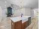 Open concept kitchen featuring an island with a sink, a dishwasher, and an open living space at 31 Mckenzie St, Shelbyville, IN 46176