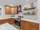 Modern kitchen featuring stainless steel appliances, wood cabinets, and white countertops at 31 Mckenzie St, Shelbyville, IN 46176