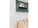 Laundry room features dark green accent wall with shelf and wood-look floors at 31 Mckenzie St, Shelbyville, IN 46176